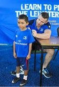 30 June 2015; Leinster Rugby's Kevin McLaughlin and Aaron Dundon headed out to the Bank of Ireland Leinster Rugby Summer Camps in Donnybrook Stadium to meet up with some local young rugby talent. Pictured is Carlos Culligan, age 6, from Clonskeagh, Dublin, having his t-shirt signed by Aaron Dundon during the Bank of Ireland Leinster Rugby Summer Camps 2015. Donnybrook Stadium, Donnybrook, Dublin. Picture credit: Dáire Brennan / SPORTSFILE