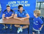 30 June 2015; Leinster Rugby's Kevin McLaughlin and Aaron Dundon headed out to the Bank of Ireland Leinster Rugby Summer Camps in Donnybrook Stadium to meet up with some local young rugby talent. Pictured are Leinster players Aaron Dundon, left, and Kevin McLaughlin, in conversation with Alfie Michael O'Neill, aged 5, from Rathmines, Dublin, during the Bank of Ireland Leinster Rugby Summer Camps 2015. Donnybrook Stadium, Donnybrook, Dublin. Picture credit: Dáire Brennan / SPORTSFILE