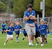 30 June 2015; Leinster Rugby's Kevin McLaughlin and Aaron Dundon headed out to the Bank of Ireland Leinster Rugby Summer Camps in Donnybrook Stadium to meet up with some local young rugby talent. Pictured is Leinster's Kevin McLaughlin, being tackled by participants during the Bank of Ireland Leinster Rugby Summer Camps 2015. Donnybrook Stadium, Donnybrook, Dublin. Picture credit: Dáire Brennan / SPORTSFILE