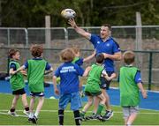30 June 2015; Leinster Rugby's Kevin McLaughlin and Aaron Dundon headed out to the Bank of Ireland Leinster Rugby Summer Camps in Donnybrook Stadium to meet up with some local young rugby talent. Pictured are Leinster's Aaron Dundon and participants in action during Bank of Ireland the Leinster Rugby Summer Camps 2015. Donnybrook Stadium, Donnybrook, Dublin. Picture credit: Dáire Brennan / SPORTSFILE