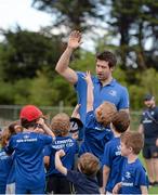 30 June 2015; Leinster Rugby's Kevin McLaughlin and Aaron Dundon headed out to the Bank of Ireland Leinster Rugby Summer Camps in Donnybrook Stadium to meet up with some local young rugby talent. Pictured are five and six year old participants as they attempt to reach Kevin McLaughlin's hand during Bank of Ireland the Leinster Rugby Summer Camps 2015. Donnybrook Stadium, Donnybrook, Dublin. Picture credit: Dáire Brennan / SPORTSFILE