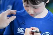 30 June 2015; Leinster Rugby's Kevin McLaughlin and Aaron Dundon headed out to the Bank of Ireland Leinster Rugby Summer Camps in Donnybrook Stadium to meet up with some local young rugby talent. Pictured is Paddy Rennick, age 7, from Sandymount, Dublin, having his t-shirt signed by Aaron Dundon, Leinster, during the Bank of Ireland Leinster Rugby Summer Camps 2015. Donnybrook Stadium, Donnybrook, Dublin. Picture credit: Dáire Brennan / SPORTSFILE