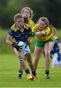4 July 2015; Caitlin Kenney, Tipperary, in action against Eimear Alcorn, Donegal. All Ireland Ladies Football U14 'B' Championship, Donegal v Tipperary. Ballymahon, Co. Longford. Picture credit: David Maher / SPORTSFILE