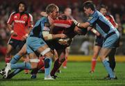20 September 2008; Rua Tipoki, Munster, is tackled by Andy Powell, left, and Ceri Sweeney, Cardiff Blues. Magners League, Munster v Cardiff Blues, Musgrave Park, Cork. Picture credit: Stephen McCarthy / SPORTSFILE