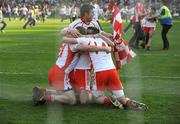21 September 2008; Tyrone players Kevin Hughes, Brian McGuigan, Sean Cavanagh and a supporter celebrate at the final whistle. GAA Football All-Ireland Senior Championship Final, Kerry v Tyrone, Croke Park, Dublin. Picture credit: Ray McManus / SPORTSFILE