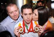 19 September 2008; Jason Smyth, from Eglinton, Co. Derry, who won two gold medals in the Men's 200m -T13 Final and Men's 100m T13 Final, with his parents Lloyd and Diane, at Dublin Airport as the Irish Paralympic Team arrived home from Beijing. Dublin Airport, Dublin. Picture credit: Stephen McCarthy / SPORTSFILE