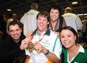 19 September 2008; Gabriel Shelly, from Bagenalstown, Co. Carlow, who won a bronze medal in the Boccia Mixed Individual - BC1, celebrates with brother Eamon, mother Pat and sister Toni at Dublin Airport as the Irish Paralympic Team arrived home from Beijing. Dublin Airport, Dublin. Picture credit: Stephen McCarthy / SPORTSFILE