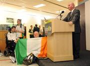 19 September 2008; Minister of State at the Department of the Taoiseach and Government Chief Whip Pat Carey speaking at a reception for Irish athletes at Dublin Airport as the Irish Paralympic Team arrived home from Beijing while Sports Assistant Patrick 'Rocky' Judge holds an Irish flag. Dublin Airport, Dublin. Picture credit: Stephen McCarthy / SPORTSFILE