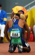 8 September 2008;  Brazil's Daniel Silva is consoled by his guide after failing to qualify during the Men's 100m - T11 Round 1 Heat 3. Beijing Paralympic Games 2008, Men's 100m - T11 Round 1 Heat 3, National Stadium, Olympic Green, Beijing, China. Picture credit: Brian Lawless / SPORTSFILE