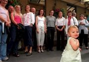 18 August 2000; Ciara O'Sullivan, daughter of Sonia O'Sullivan, walks by as a group photo is taken during a reception for members of the Ireland Olympic team at the Guinness Hopstore in Dublin prior to the Summer Olympic Games in Sydney. Photo by Brendan Moran/Sportsfile