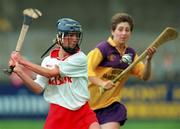 12 August 2000; Sinead O'Callaghan of Cork in action against Fiona Dunne of Wexford during the All-Ireland Senior Camogie Championship Semi-Final match between Cork and Wexford at Parnell Park in Dublin. Photo by David Maher/Sportsfile