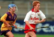 12 August 2000; Linda Mellerick of Cork in action against Lennie Houlihan of Wexford during the All-Ireland Senior Camogie Championship Semi-Final match between Cork and Wexford at Parnell Park in Dublin. Photo by David Maher/Sportsfile