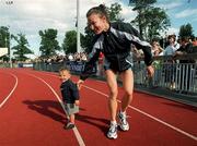 20 August 2000; Sonia O'Sullivan of Ballymore Cobh AC, Cork, with her daughter Ciara, after winning the Women's 1500m Final during the AAI National Track and Field Championships of Ireland at Morton Stadium in Dublin. Photo by Pat Murphy/Sportsfile