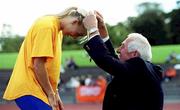 20 August 2000; 1956 Olympic 1500m Gold Medallist Ronnie Delany presents a gold medal to Women's 100m Champion Sarah Reilly during the AAI National Track and Field Championships of Ireland at Morton Stadium in Dublin. Photo by Brendan Moran/Sportsfile