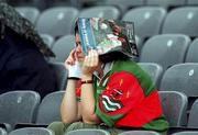 27 August 2000; A Mayo supporter shields herself from the rain with a match programme during the All-Ireland Minor Football Championship Semi-Final match between Mayo and Westmeath at Croke Park in Dublin. Photo by Aoife Rice/Sportsfile