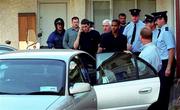 29 August 2000; Republic of Ireland players Mark Kennedy and Phil Babb, accompanied by Mick Byrne and team security officer Tony Hickey, leave Dublin Dictrict Court having been arrested in Dublin the previous night. Both players were subsequently dropped from the Republic of Ireland squad for the FIFA World Cup Qualifier in the Netherlands. Photo by Ray Lohan/Sportsfile