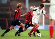 1 September 2000; Mark Herrick of Cork City in action against Kevin Hunt and Anthony Hopper of Bohemians during the Eircom League Premier Division match between Bohemians and Cork City at Dalymount Park in Dublin. Photo by Brendan Moran/Sportsfile