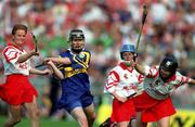 3 September 2000; Emer McDonnell of Tipperary in action against Linda Mellerick, left, and Ursula Troy of Cork during the All-Ireland Senior Camogie Championship Final match between Cork and Tipperary at Croke Park in Dublin. Photo by Aoife Rice/Sportsfile