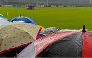 5 July 2015; Spectators take shelter from the rain under umbrellas in the stand. GAA Hurling All-Ireland Senior Championship, Round 1, Westmeath v Limerick. Cusack Park, Mullingar, Co. Westmeath. Picture credit: Piaras Ó Mídheach / SPORTSFILE