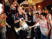 22 September 2008; Tyrone manager Mickey Harte carries the Sam Maguire Cup during the teams departure from Citywest Hotel, Saggart, Co. Dublin. Picture credit: Pat Murphy / SPORTSFILE