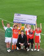 30 September 2008; The love for, and pride in, the GAA, which is shared by thousands of GAA fans around the country, is responsible for raising 3.4 million euro for GAA clubs and schools over the past four years. This innovative but simple scheme sees 15% of call costs being donated back to customers' preferred club or school, while at the same time saving them money on their home phone and Broadband bills. All 32 County Boards support the scheme which sees 2,500 Clubs around the country receive cheques from Gaelic Telecom twice a year. The amount raised by the 6 counties between January and June of this year is 110,000 euros. Pictured at the announcement is Ciaran Doyle, General Manager, Gaelic Telecom, with from left, Darragh Gibbons, age 10, whose county raised 7,500 euros, Hajer Mani, age 10, Armagh, whose county raised 27,700 euros, Luke Bolger, age 10, Antrim, whose county raised 10,200 euros, Ashley Sweeney, age 10, Tyrone, whose county raised 26,700 euros, Emma McGarry, age 9, Down, whose county raised 18,600 euros and Conor Dunne, age 9, Derry, whose county raised 19,300 euros. Croke Park, Dublin. Picture credit: Brendan Moran / SPORTSFILE