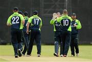 10 July 2015; The Irish players runs to congratulate John Mooney, right, after taking the first wicket of Stephen Baard, Namibia. ICC World Twenty20 Qualifier 2015, Ireland v Namibia. Stormont, Belfast. Picture credit: Oliver McVeigh / ICC / SPORTSFILE