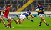 11 July 2015;Conor Sweeney passes to Philip Austin, Tipperary, under pressure from Anthony Williams, Louth. GAA Football All-Ireland Senior Championship, Round 2B, Tipperary v Louth, Semple Stadium, Thurles, Co. Tipperary. Picture credit: Ray McManus / SPORTSFILE