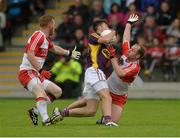 11 July 2015; Eoghan Nolan, Wexford, in action against Fergal Doherty and Sean Leo McGoldrick, Derry. GAA Football All-Ireland Senior Championship, Round 2B, Derry v Wexford, Owenbeg, Derry. Picture credit: Oliver McVeigh / SPORTSFILE
