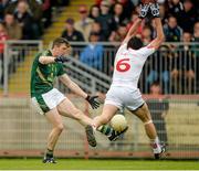 11 July 2015; Kevin Reilly, Meath, kicks a point despite the best efforts of Joe McMahon, Tyrone. GAA Football All-Ireland Senior Championship, Round 2B, Tyrone v Meath, Healy Park, Omagh, Co. Tyrone. Picture credit: Brendan Moran / SPORTSFILE