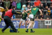 11 July 2015; Donncha Tobin, Meath, is restrained from resuming his position by the Meath team physio in the final moments of the game after an accidental clash with Colm Cavanagh, Tyrone. GAA Football All-Ireland Senior Championship, Round 2B, Tyrone v Meath, Healy Park, Omagh, Co. Tyrone. Picture credit: Brendan Moran / SPORTSFILE