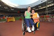 10 September 2008; Ireland's Catherine Wayland, from New Ross, Wexford, with escort Mairead Farquharson, during the Women's Discus - F32-34/51-53. Catherine finished 6th overall with a Season's Best distance of 6.13. Beijing Paralympic Games 2008, Women's Discus - F32-34/51-53, National Stadium, Olympic Green, Beijing, China. Picture credit: Brian Lawless / SPORTSFILE