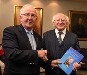 12 July 2015; President Michael D Higgins, who was a guest of the Munster Council at the game, is presented with a copy of 'Tom Semple and the Thurles Blues', a biography of Tom Semple and his legendary Thurles Blues written by Liam Ó Donnchú, by Munster Chairman Robert Frost after the game. Munster GAA Hurling Senior Championship Final, Tipperary v Waterford, Semple Stadium, Thurles, Co. Tipperary. Picture credit: Ray McManus / SPORTSFILE