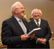 12 July 2015; President Michael D Higgins, who was a guest of the Munster Council at the game, is presented with a copy of 'Tom Semple and the Thurles Blues', a biography of Tom Semple and his legendary Thurles Blues written by Liam Ó Donnchú, by Munster Chairman Robert Frost after the game. Munster GAA Hurling Senior Championship Final, Tipperary v Waterford, Semple Stadium, Thurles, Co. Tipperary. Picture credit: Ray McManus / SPORTSFILE