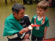 13 July 2015; Ireland's Thomas Barr pictured with Ben Lyons, aged 4, from Baldoyle, Dublin, in Dublin Airport on his arrival home from the World University Games in Gwangju South Korea. Dublin Airport, Dublin. Picture credit: Piaras Ó Mídheach / SPORTSFILE