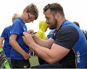 16 July 2015; Cian Healy and Gordon D'Arcy of Leinster Rugby came out to the Bank of Ireland Summer Camp to meet up with some local young rugby talent at Lansdowne FC. Pictured is Gordon D'Arcy signing a t-shirt for one of the participants of the summer camp. Lansdowne FC, Lansdowne Road, Dublin. Picture credit: Seb Daly / SPORTSFILE