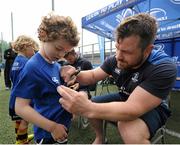 16 July 2015; Cian Healy and Gordon D'Arcy of Leinster Rugby came out to the Bank of Ireland Summer Camp to meet up with some local young rugby talent at Lansdowne FC. Pictured is Cian Healy signing a t-shirt for one of the participants of the summer camp. Lansdowne FC, Lansdowne Road, Dublin. Picture credit: Seb Daly / SPORTSFILE
