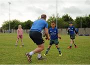16 July 2015; Luke Fitzgerald and Dave Kearney of Leinster Rugby came out to the Bank of Ireland Summer Camp to meet up with some local young rugby talent in Greystones RFC. Pictured is Luke Fitzgerald passing the ball to a camp participant. Greystones RFC, Greystones, Co. Wicklow. Picture credit: Sam Barnes / SPORTSFILE