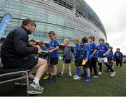 16 July 2015; Cian Healy and Gordon D'Arcy of Leinster Rugby came out to the Bank of Ireland Summer Camp to meet up with some local young rugby talent at Lansdowne FC. Pictured are participants of the summer camp queuing up to get autographs from Gordon D'Arcy. Lansdowne FC, Lansdowne Road, Dublin. Picture credit: Seb Daly / SPORTSFILE