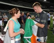 21 October 2008; Martin McGrath signs a flag for Marie Healy, a resident of Perth, from Ballygar, Co. Galway, after the Ireland International Rules squad training. 2008 International Rules tour, Subiaco Oval, Perth, Australia. Picture credit: Ray McManus / SPORTSFILE