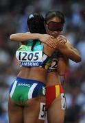 15 September 2008; China's Chunmiao Wu, who finished first, consoles Brazil's Adria Santos after she failed to qualify during the Women's 200m - T11 heats. Beijing Paralympic Games 2008, Women's 200m - T11, Heat 2, National Stadium, Olympic Green, Beijing, China. Picture credit: Brian Lawless / SPORTSFILE