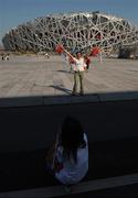 15 September 2008; A Chinese fan poses for a photo outside the 'Bird's Nest'. Beijing Paralympic Games 2008, National Stadium, Olympic Green, Beijing, China. Picture credit: Brian Lawless / SPORTSFILE