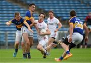 18 July 2015; Colm Cavanagh, Tyrone, in action against Michael Quinlivan and Brian Fox, left, Tipperary. GAA Football All-Ireland Senior Championship, Round 3B, Tipperary v Tyrone. Semple Stadium, Thurles, Co. Tipperary. Picture credit: Diarmuid Greene / SPORTSFILE