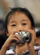 15 September 2008; A young chinese girl takes photos. Beijing Paralympic Games 2008, National Stadium, Olympic Green, Beijing, China. Picture credit: Brian Lawless / SPORTSFILE