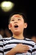 15 September 2008; A young chinese fan stands for the National Anthem. Beijing Paralympic Games 2008, National Stadium, Olympic Green, Beijing, China. Picture credit: Brian Lawless / SPORTSFILE