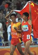 15 September 2008; China's  Zhen Zhang celebrates with his guide after winning the Men's 1500m - T11 Final. Beijing Paralympic Games 2008, Men's 1500m - T11 Final, National Stadium, Olympic Green, Beijing, China. Picture credit: Brian Lawless / SPORTSFILE