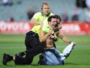 24 October 2008; A supporter, who ran onto the pitch after the game, is caught by security personnel 2008 Toyota International Rules Series, Australia v Ireland, Subiaco Oval, Perth, Western Australia. Picture credit: Ray McManus / SPORTSFILE