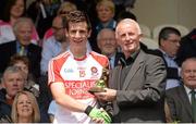 19 July 2015; Pictured is Vincent Litchfield, Customer Relationship Manager for Electric Ireland, proud sponsor of the GAA All-Ireland Minor Championships, presenting Shane McGuigan, Derry, with the Player of the Match award for his outstanding performance in the Electric Ireland Ulster Minor Football Championship Final. Throughout the Championship fans can follow the action, support the Minors and be a part of something major through the hashtag #ThisIsMajor. Electric Ireland Ulster GAA Football Minor Championship Final, Cavan v Derry, St Tiernach's Park, Clones, Co. Monaghan. Picture credit: Oliver McVeigh / SPORTSFILE