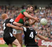 19 July 2015; Aidan O'Shea, Mayo, in action against Ross Donavan, left and Daniel Maye, Sligo. Connacht GAA Football Senior Championship Final, Mayo v Sligo, Dr. Hyde Park, Roscommon. Picture credit: David Maher / SPORTSFILE