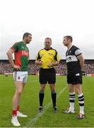 19 July 2015; Referee Padraig O'Sullivan tosses the coin between captains Keith Higgins, left, Mayo, and Mark Breheny, Sligo. Connacht GAA Football Senior Championship Final, Mayo v Sligo, Dr. Hyde Park, Roscommon. Picture credit: David Maher / SPORTSFILE