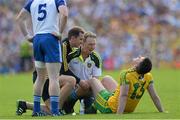 19 July 2015; Patrick McBrearty, Donegal, is attended to by physiotherapist Dermot Simpson and Dr Kevin Moran during the game. Ulster GAA Football Senior Championship Final, Donegal v Monaghan, St Tiernach's Park, Clones, Co. Monaghan. Picture credit: Oliver McVeigh / SPORTSFILE